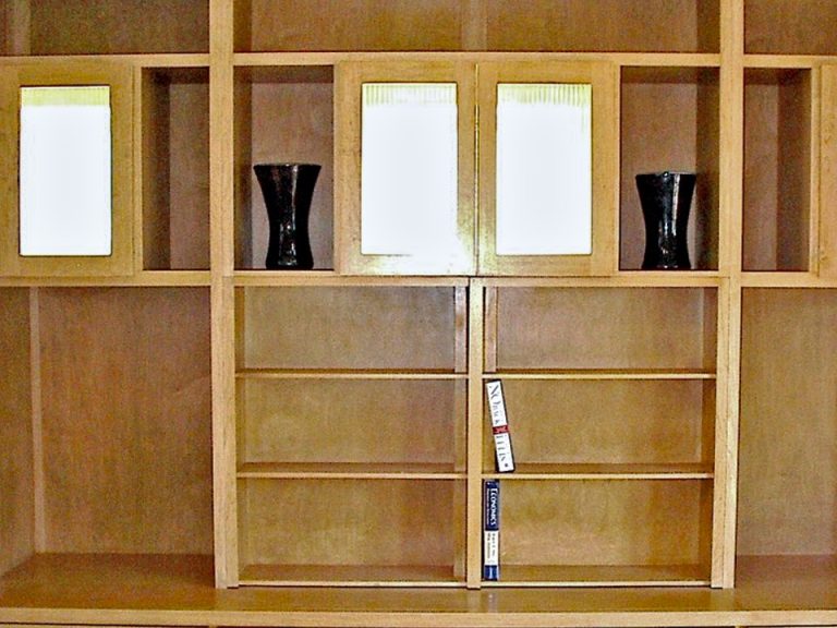 Bookcase with hidden TV. Lighted panels are existing windows.